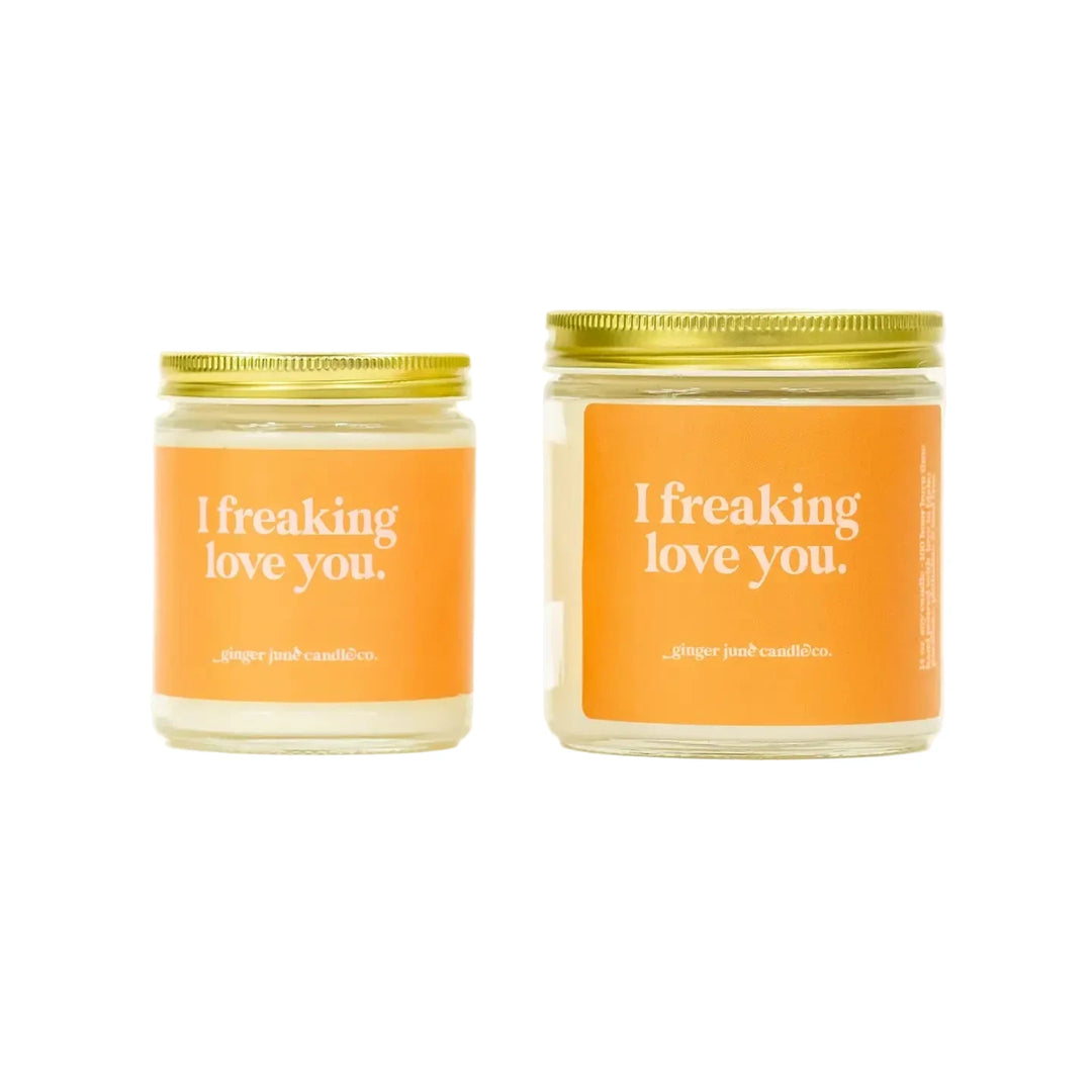 Two soy candles in glass jars with gold lids, each labeled “I freaking love you.”
