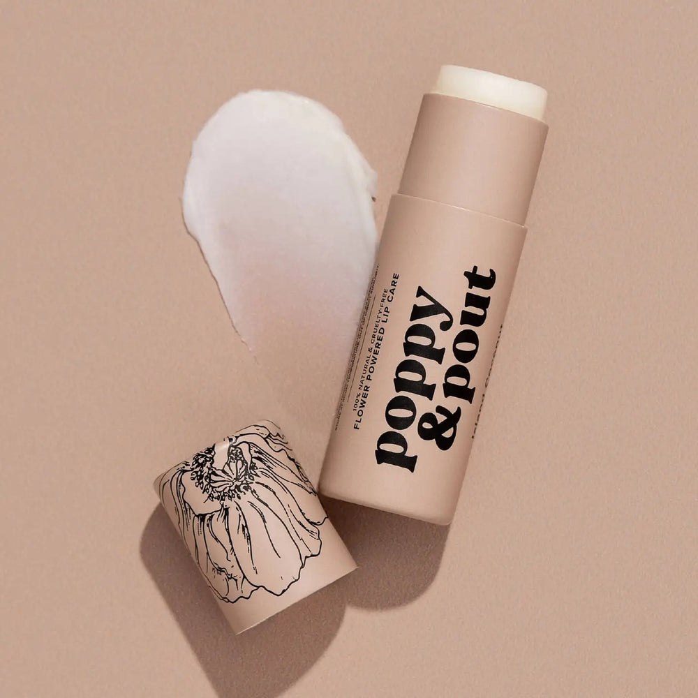 Eco-friendly lip balm tube labeled “poppy & pout” shown with cap off next to product swatch. 