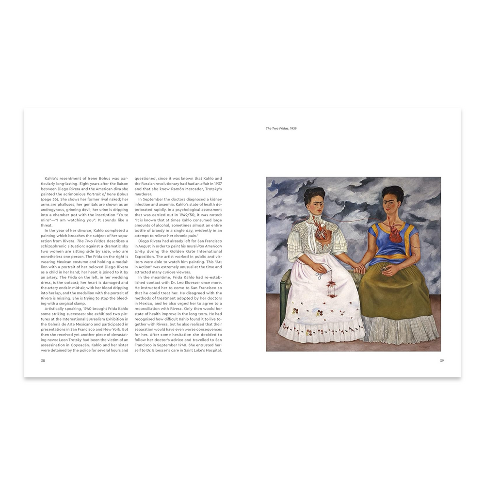 Kahlo Interior Spread
An interior spread from a Frida Kahlo monograph showing pages 38–39, with biographical text on the left alongside a full reproduction of her 1939 painting The Two Fridas, depicting two seated self-portrait figures in contrasting dress connected by an exposed artery, set against a stormy sky.