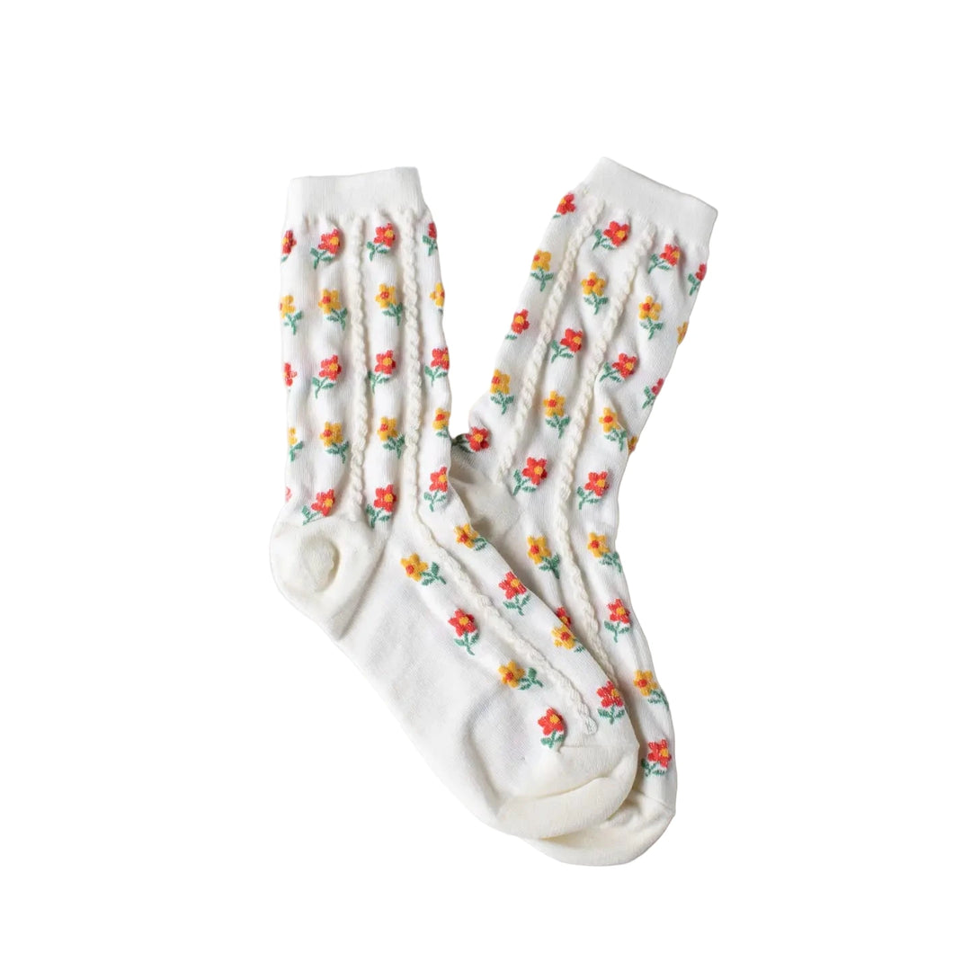 Pair of cream socks with an all-over pattern of small red and yellow flowers.