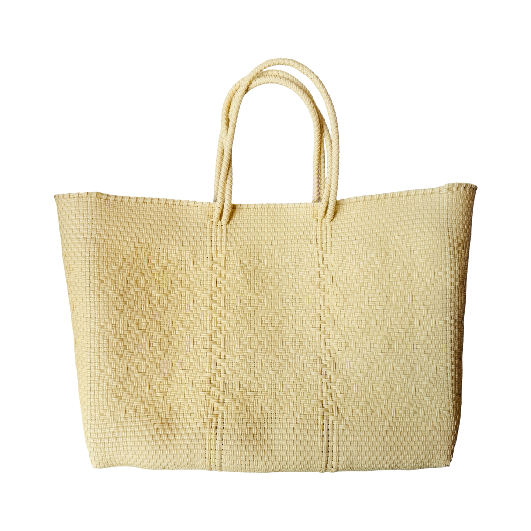 cream recycled plastic woven tote featuring a unique weaved pattern and braided handles.