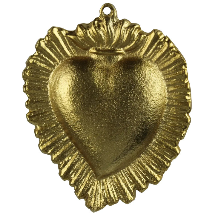 A gold-colored brass Milagro Sacred Heart charm with a textured surface and a small ring at the top for hanging.
