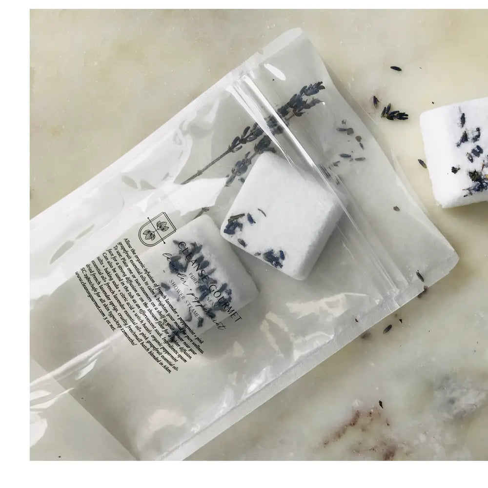 Alternate view of plastic pouch of lavender shower steamers by Cleanse Gourmet has package content description in fine black print.