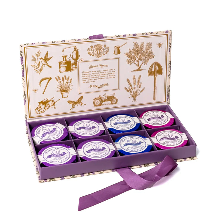 Open gift box showing eight foil wrapped shower steamers in Lavender, Chamomile Lavender, and Sage Lavender.