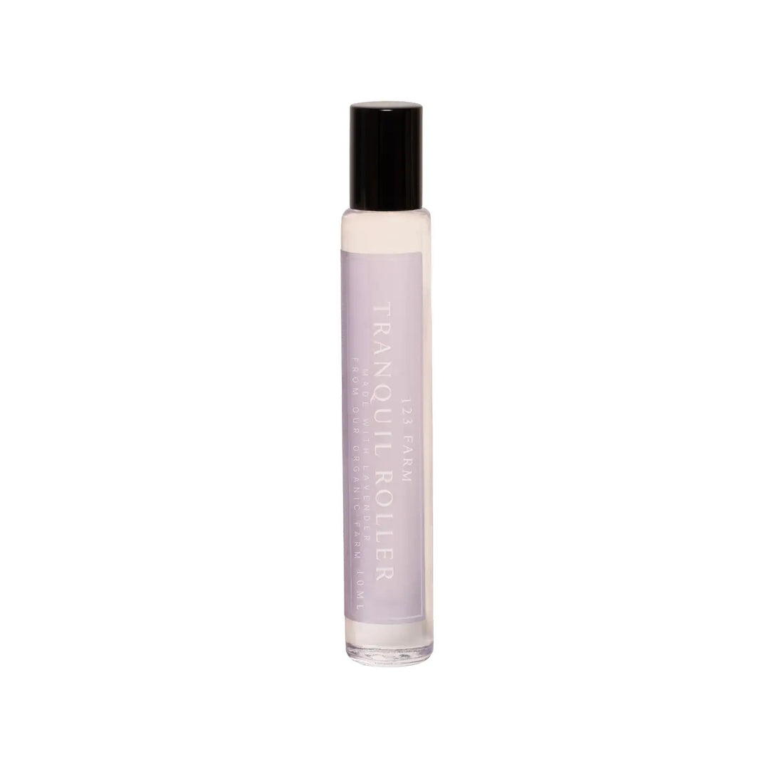 A slim 10ml glass roller bottle with a soft lavender label reading "Tranquil Roller." 