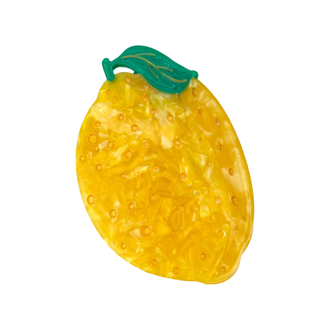 lemon shaped hair clip with a small green leaf