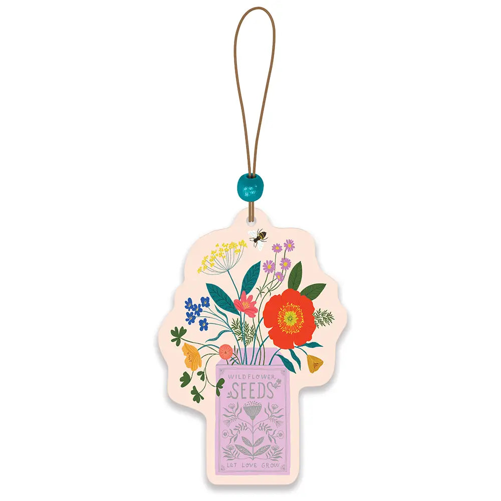 Flat car air freshener features illustration of colorful assortment of flowers growing out from a seed envelope. it hangs from a thin tan cord with a blue faceted bead accent.