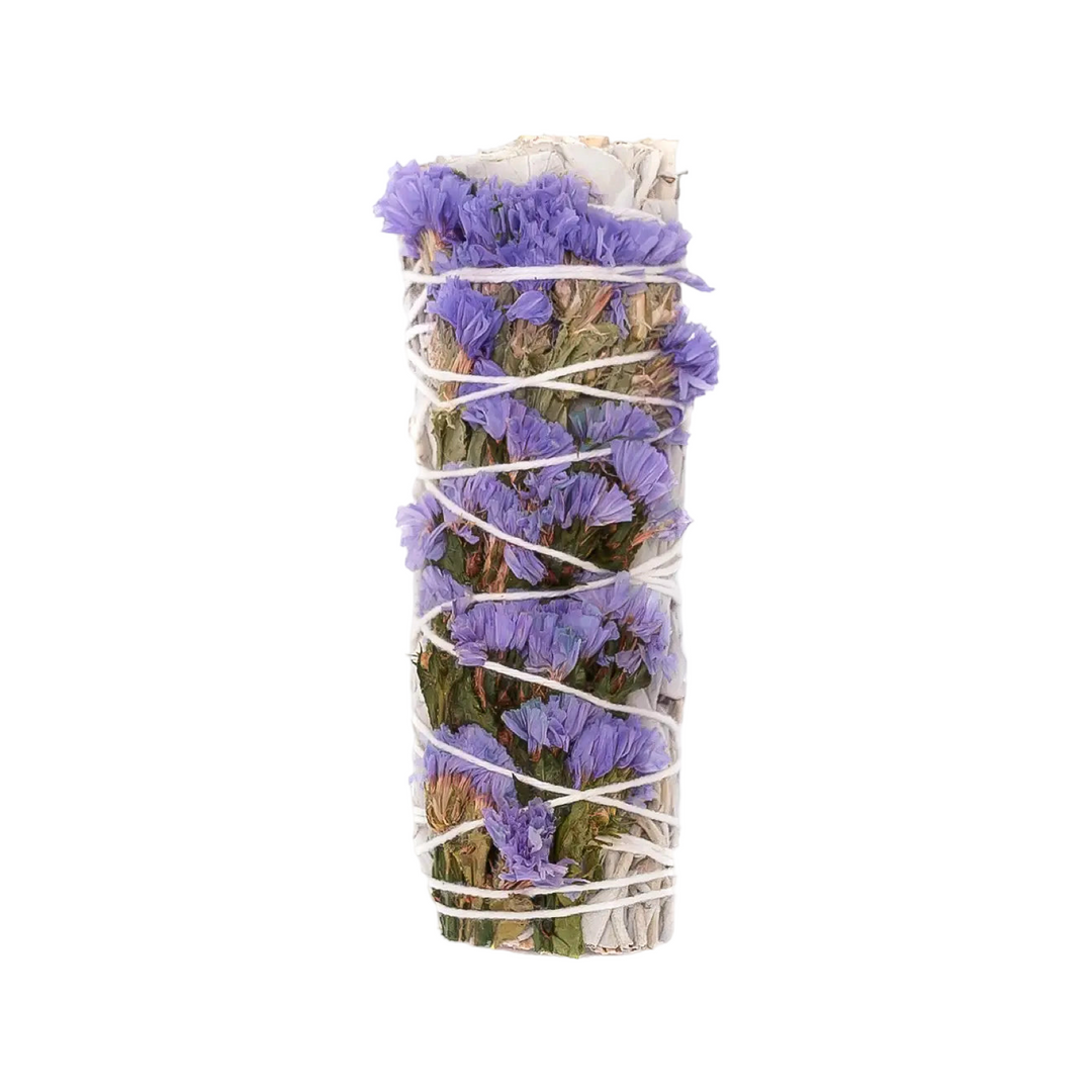 A 4-inch sage bundle wrapped with soft purple lilac sinuata statice flowers and tied with white string.