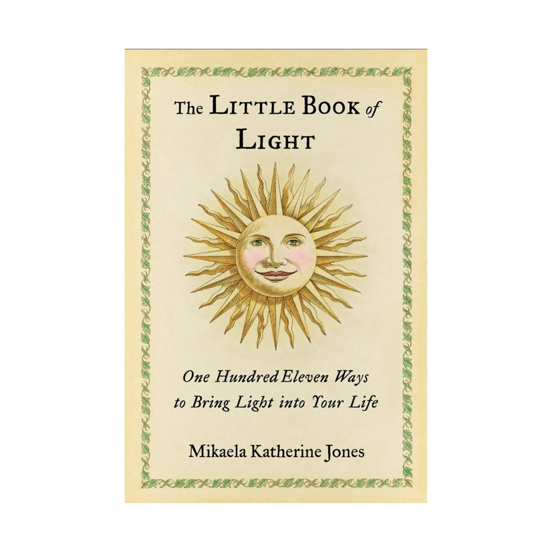 Book titled 'The Little Book of Light' features light yellow cover with illustrated image of a radiating sun with facial features. A delicate green leaf design borders the light yellow cover. Book title, content description and author are listed at the top and bottom in black text.