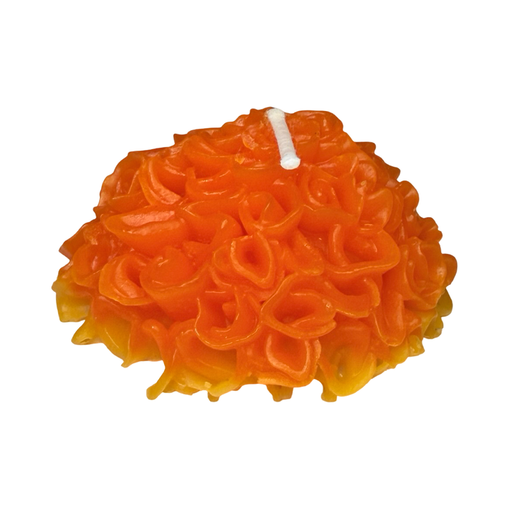 Side view of a Marigold shaped candle in orange and yellow