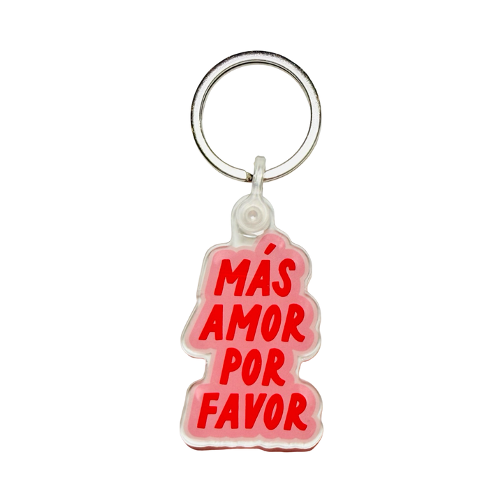 Acrylic keychain with pink and red text reading "Más Amor Por Favor.