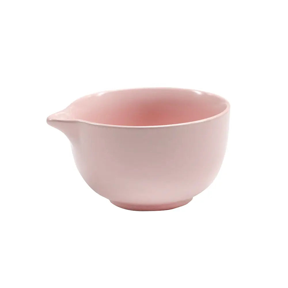 Light pink round ceramic matcha bowl in front of a white background.