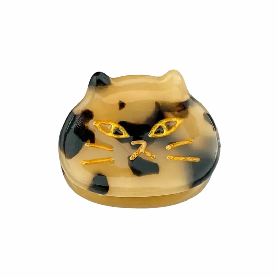 mini cat hair clip with a tortoiseshell pattern with golden etched details