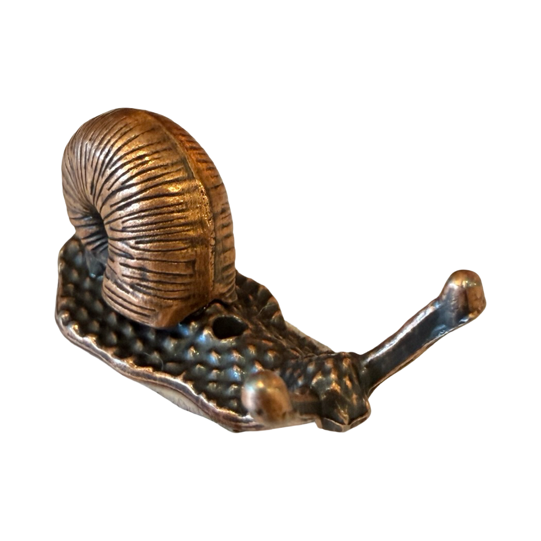 bronze colored figurine of a snail