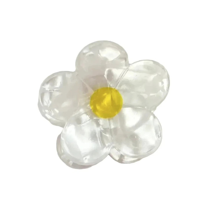 Clear iridescent mini flower claw clip with a yellow center.