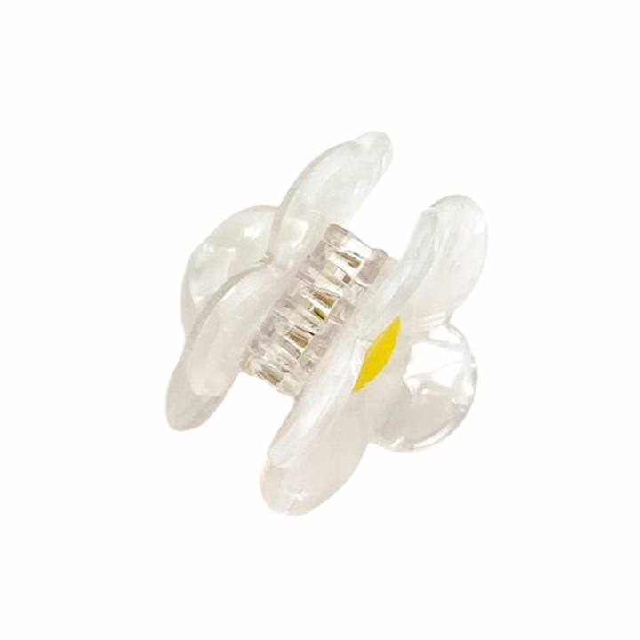 Clear iridescent mini flower claw clip with a yellow center.