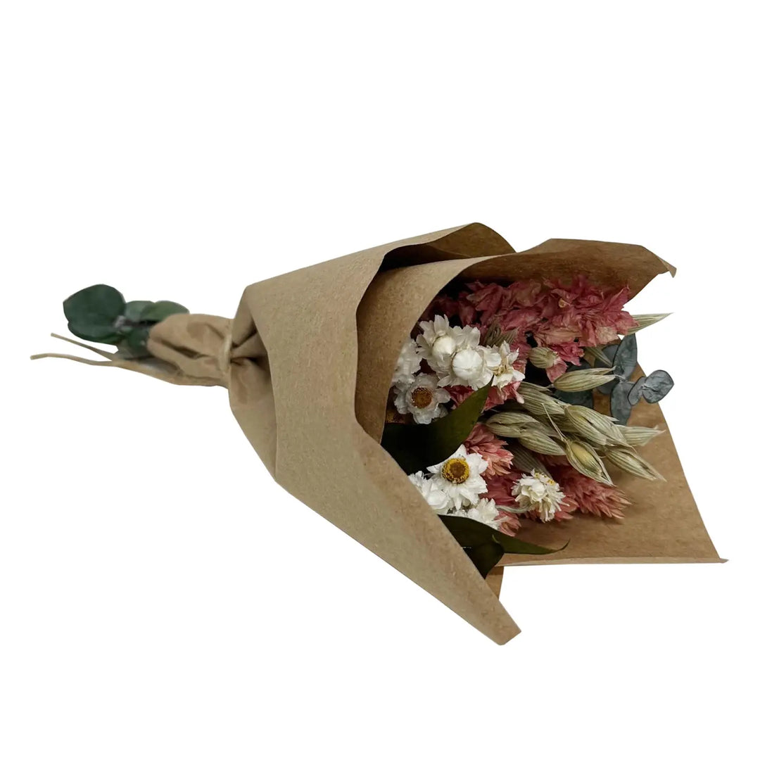 Small kraft-wrapped dried bouquet featuring pink larkspur, sprigs of baby eucalyptus, and white accent flowers, shown on a white background.