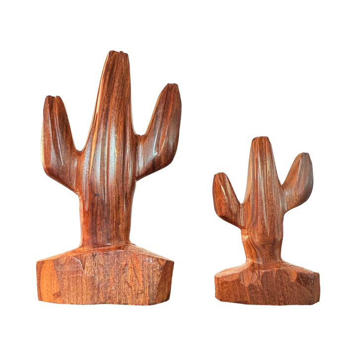 Set of different size handcarved wooden saguaro cactus sculptures made from polished ironwood with natural grain variations.