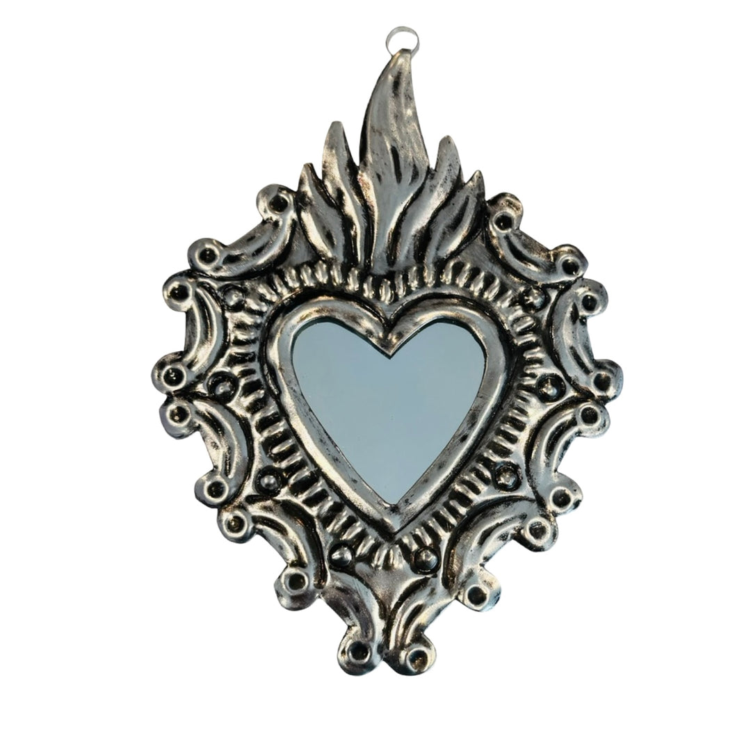 Decorative heart-shaped mirror with ornate silver frame 