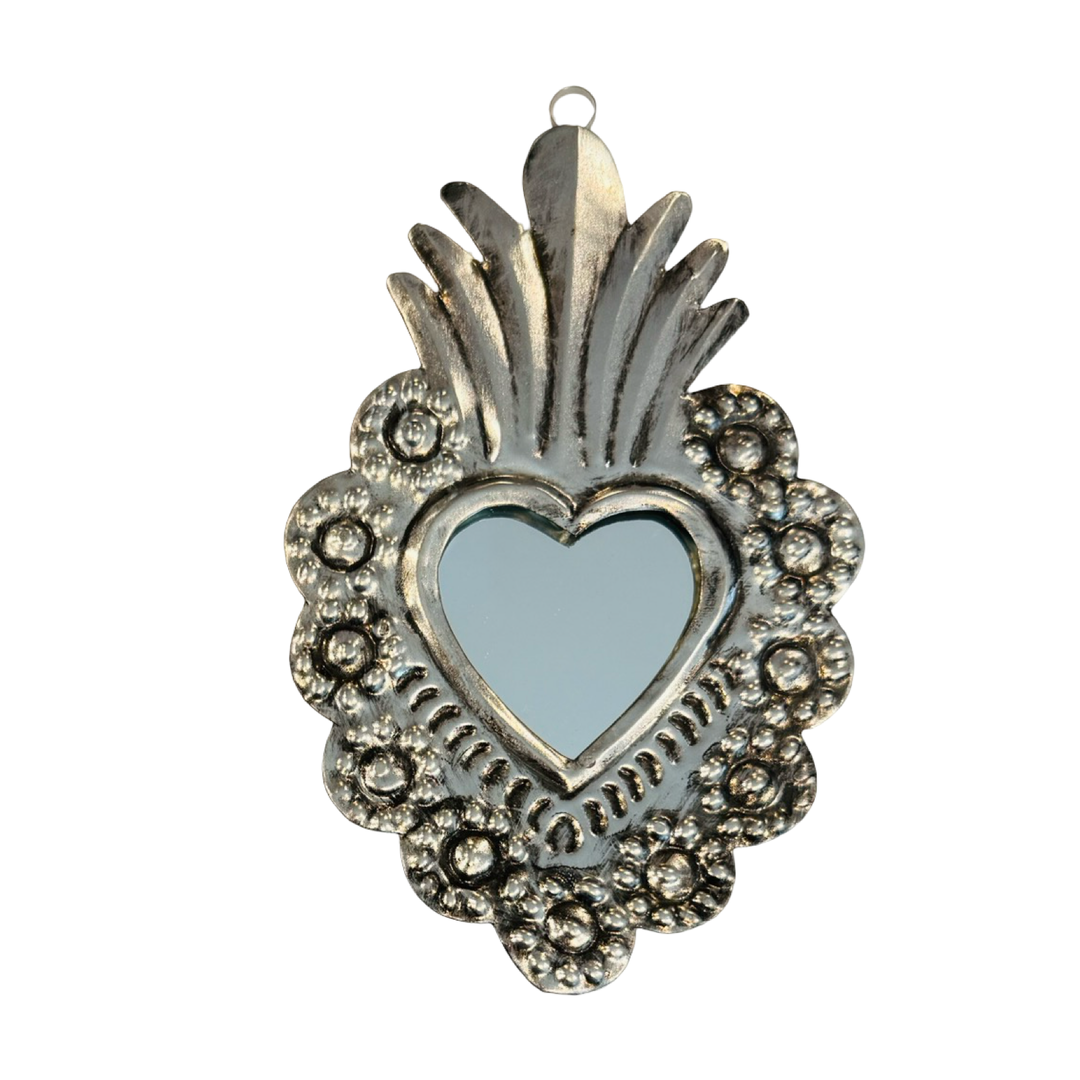 Tin heart shaped wall hanging with a mirror in the center.