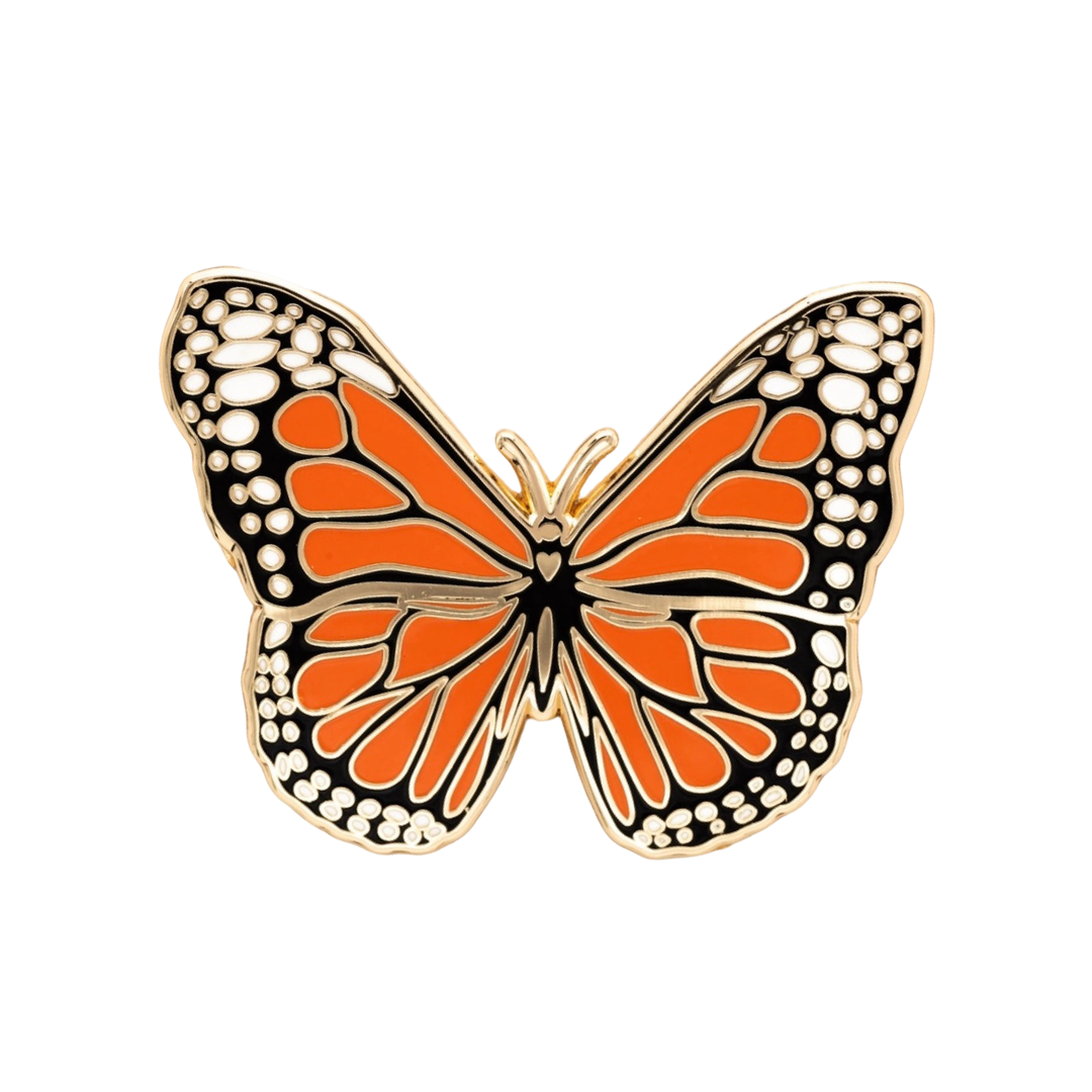 A gold tone black orange and white hard enamel monarch butterfly pin.