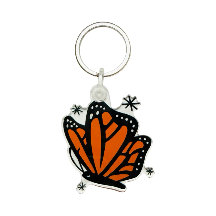 Acrylic monarch butterfly keychain with black and orange wings and star accents.