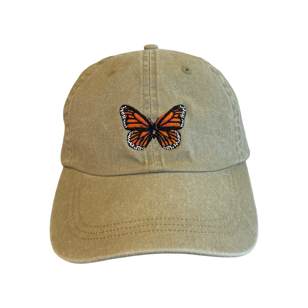 khaki hat with a monarch embroidered in the center