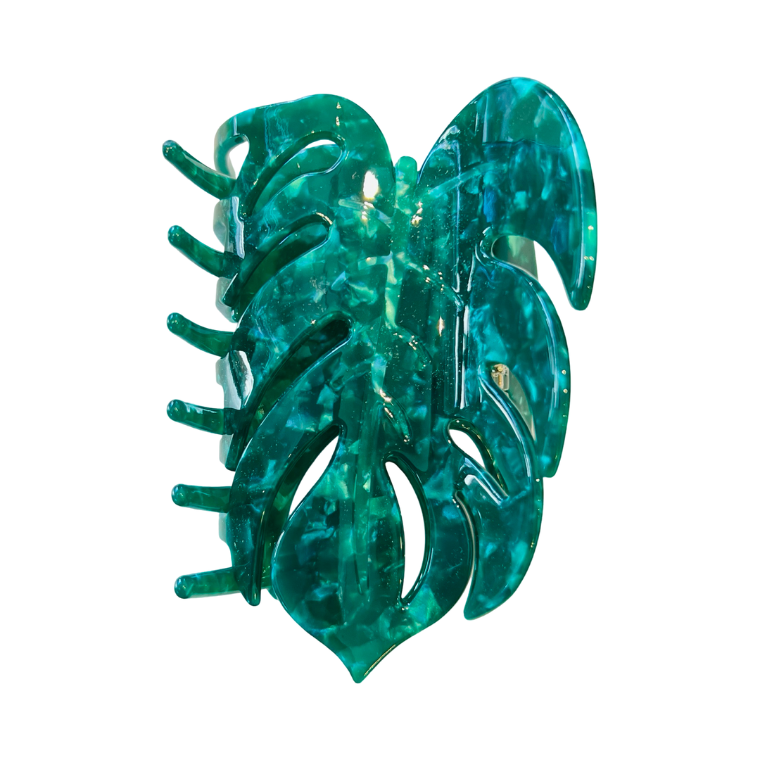 A green, monstera leaf-shaped hair clip made of acetate.