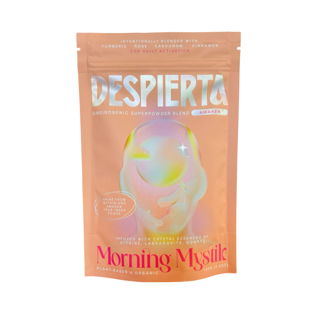 A peach-colored 4.2 oz pouch of Despierta – Morning Mystic oneirogenic superpowder blend. The packaging features a holographic, dreamy design with soft pastel tones and ethereal artwork. 