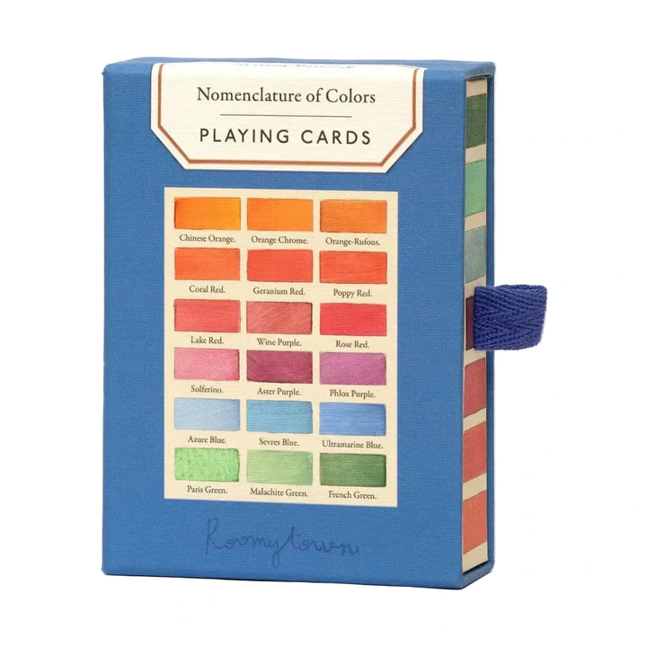 Nomenclature of Colors Playing Cards by Roomytown in a cobalt blue slide-out box featuring a vintage color swatch chart with named hues on the front and a woven navy ribbon pull tab on the side