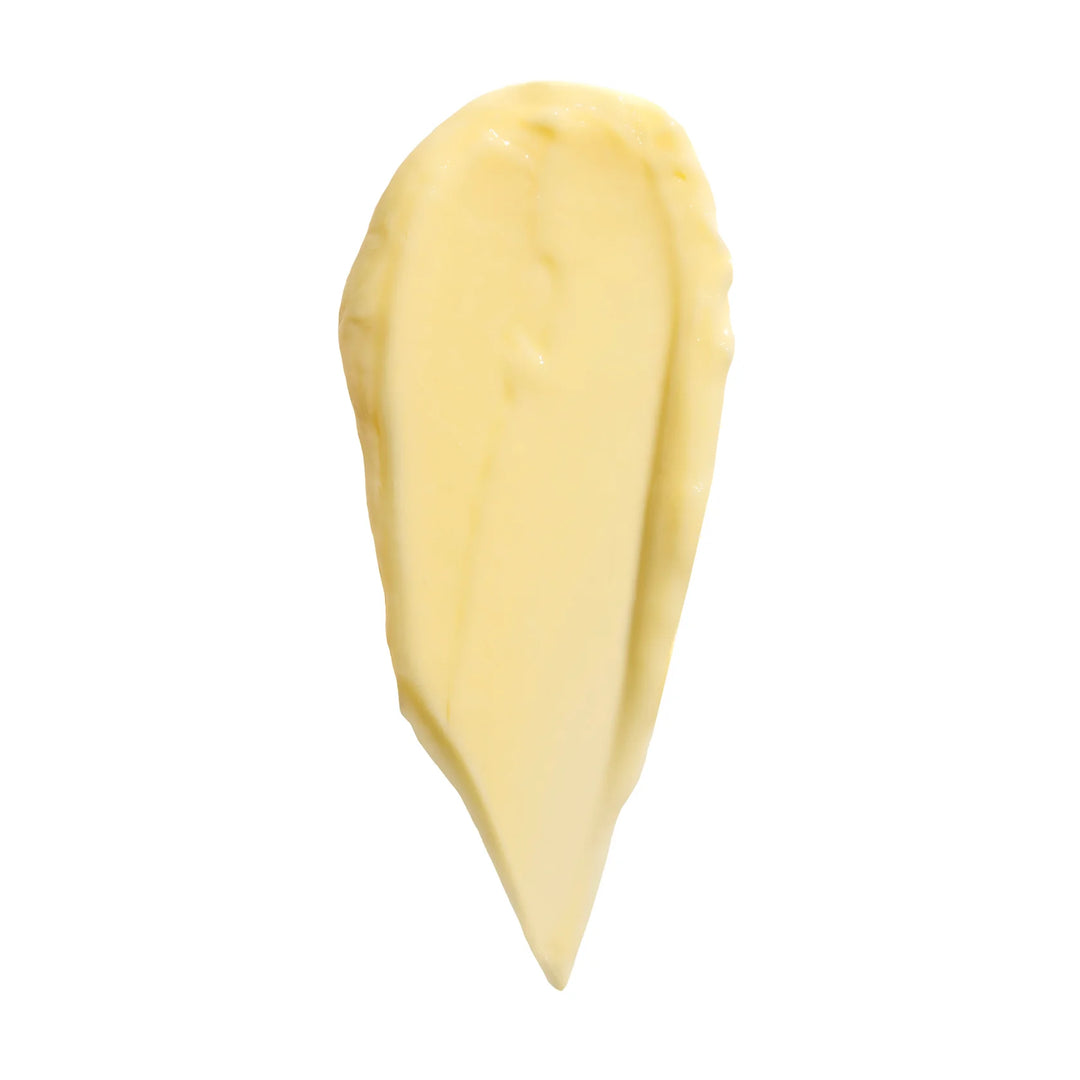 Dollop of thick yellow Nopalera body cream on a white background.