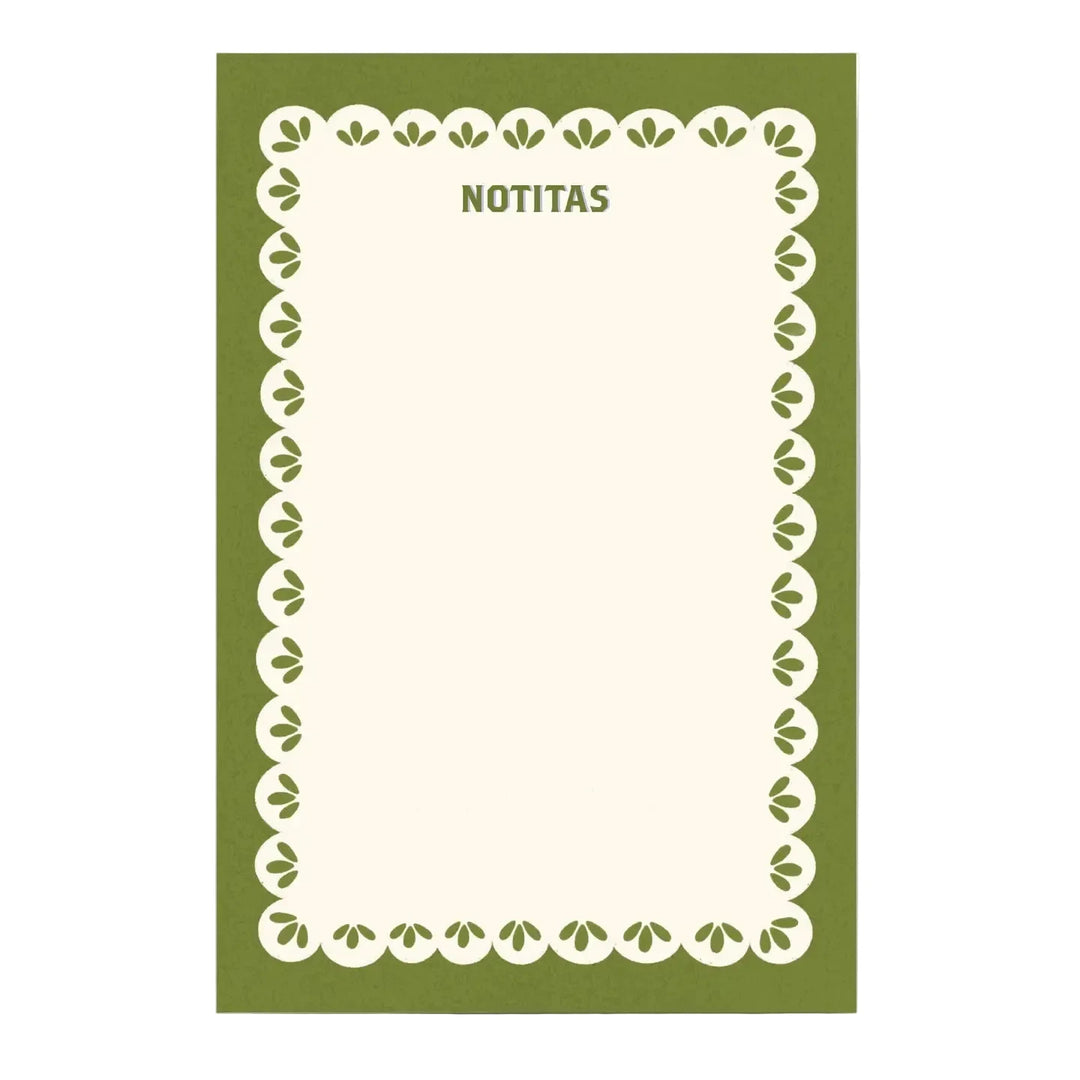A notepad with an olive green cover, a cream scalloped border with leaf details, and "NOTITAS" printed at the top in green lettering.