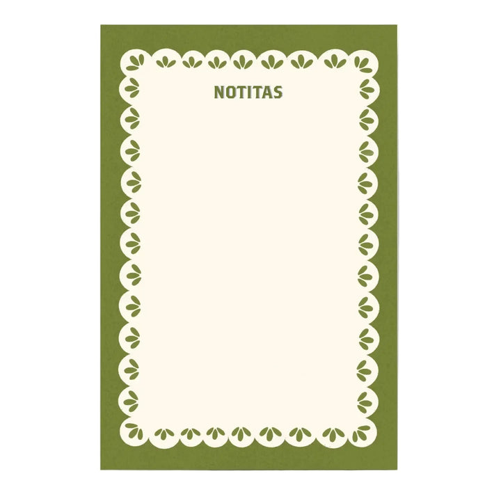 A notepad with an olive green cover, a cream scalloped border with leaf details, and "NOTITAS" printed at the top in green lettering.