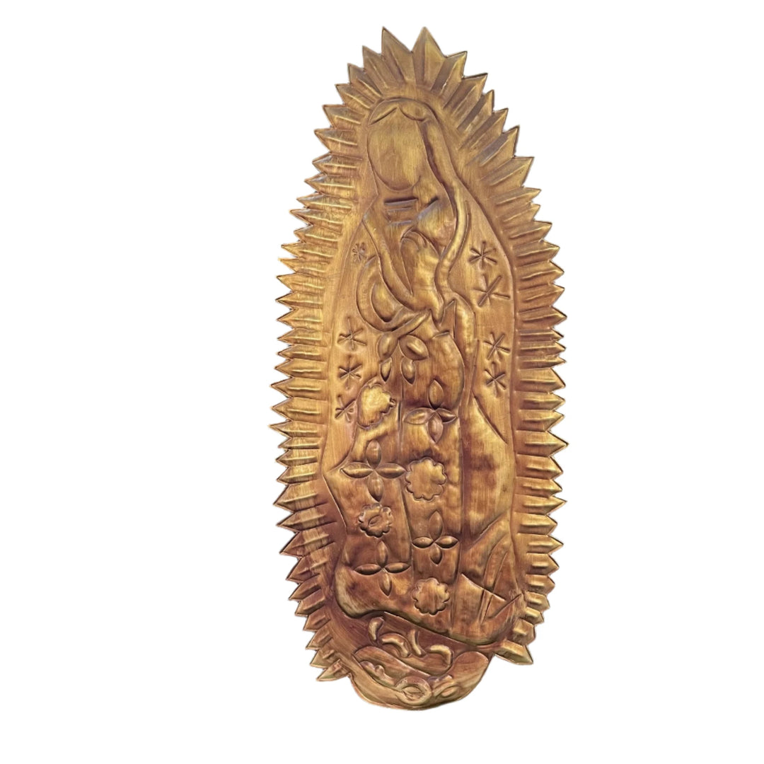 hammered gold colored tin wall hanging of Our Lady of Guadalupe.