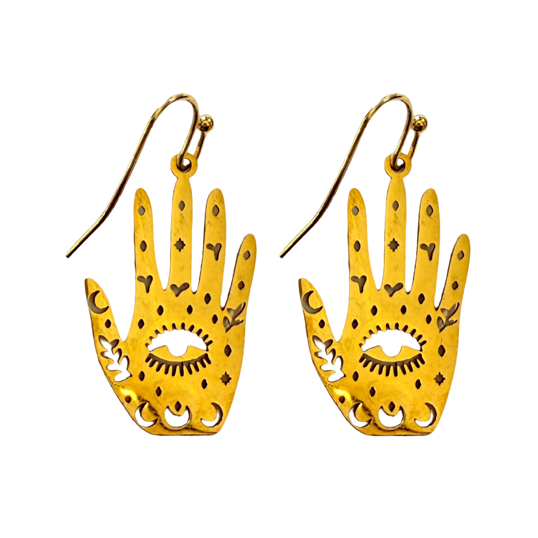 Set of gold earrings feature a hand-shaped design with intricate cutouts of moons, stars, and a central all-seeing eye.