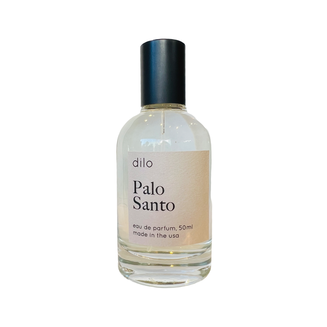 photo of branded clear glass perfume bottle with black lid and dilo branded label.