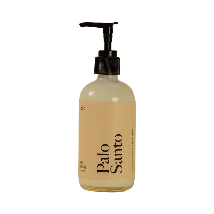 8 oz clear glass pump bottle of Dilo Palo Santo Hand Lotion with a warm beige label and bold black typography.