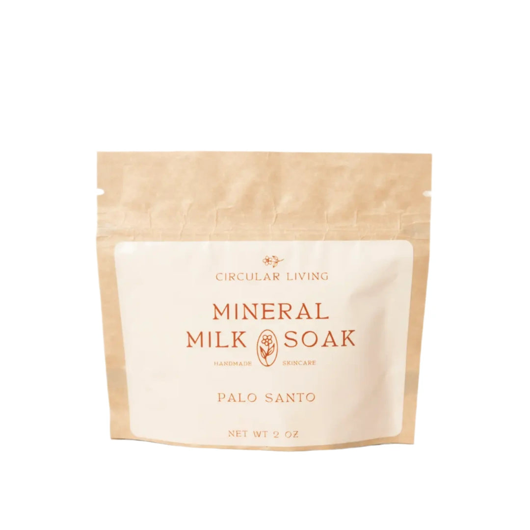 A kraft paper sachet labeled "Circular Living Mineral Milk Soak – Palo Santo".