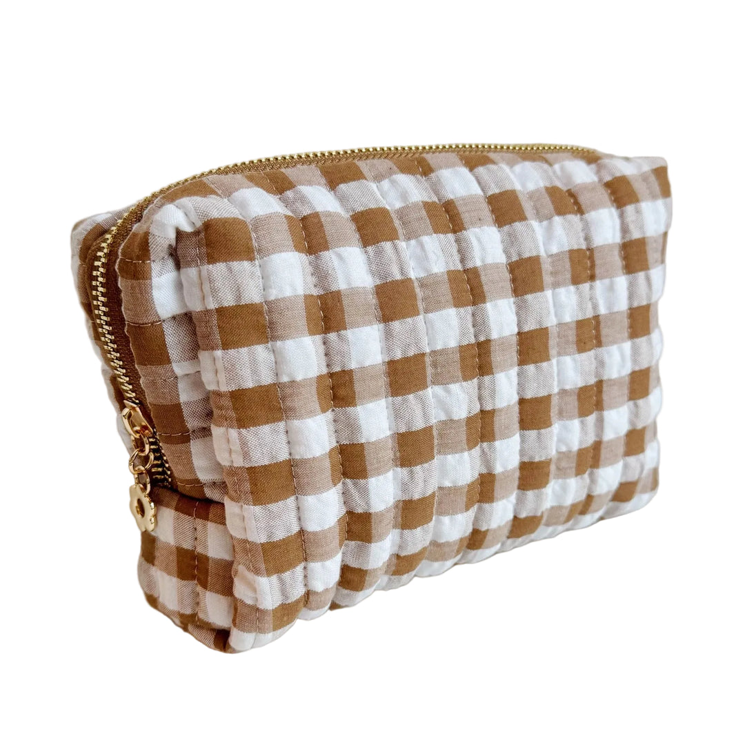 Quilted brown-and-white gingham cosmetic pouch with a gold zipper.