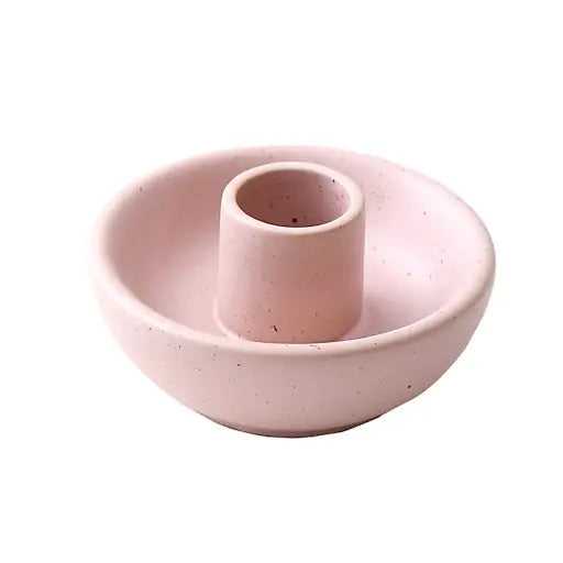 Light pink round ceramic candle holder on a white background.