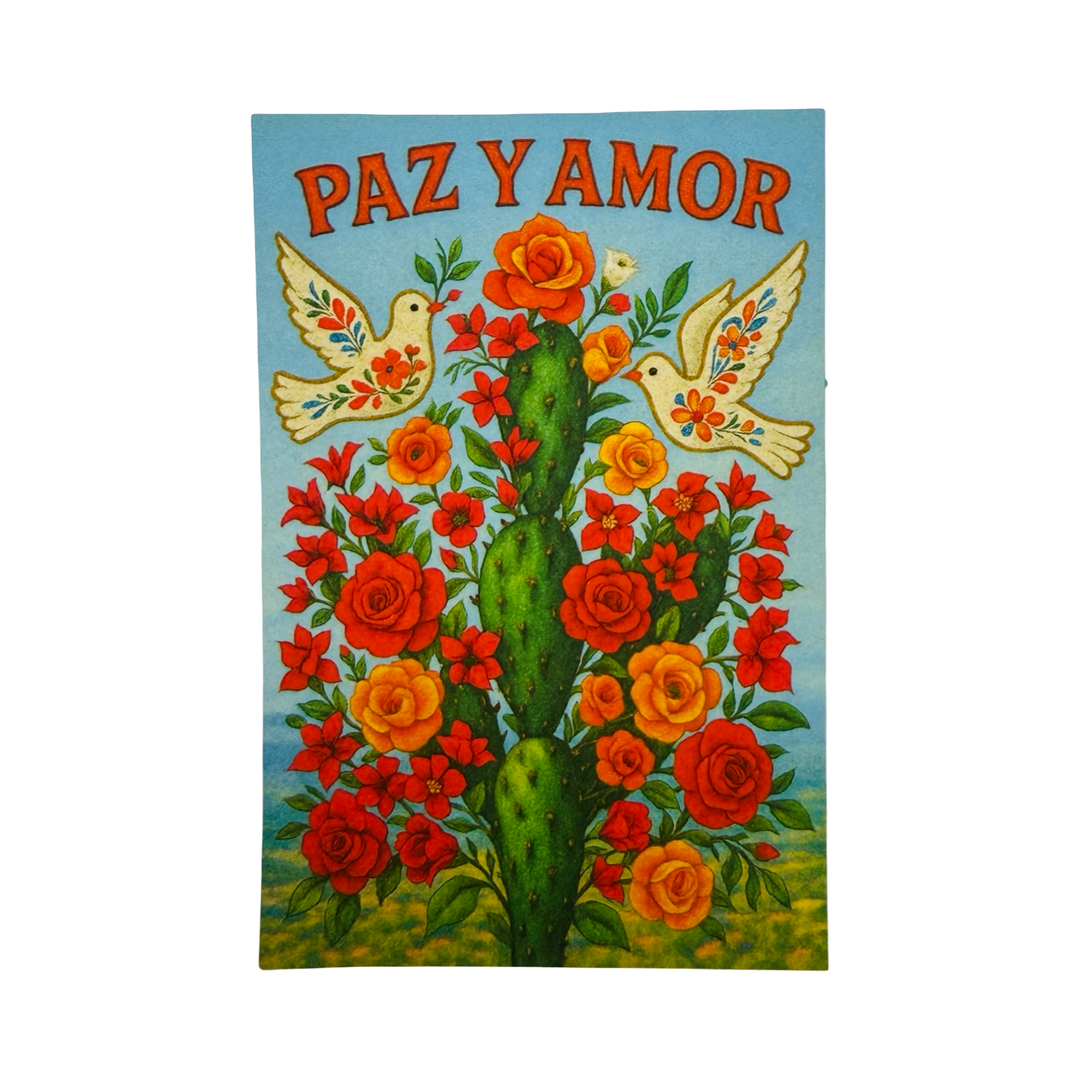 Sticker reading “Paz y Amor” above an illustrated cactus surrounded by flowers with two doves flying on either side.