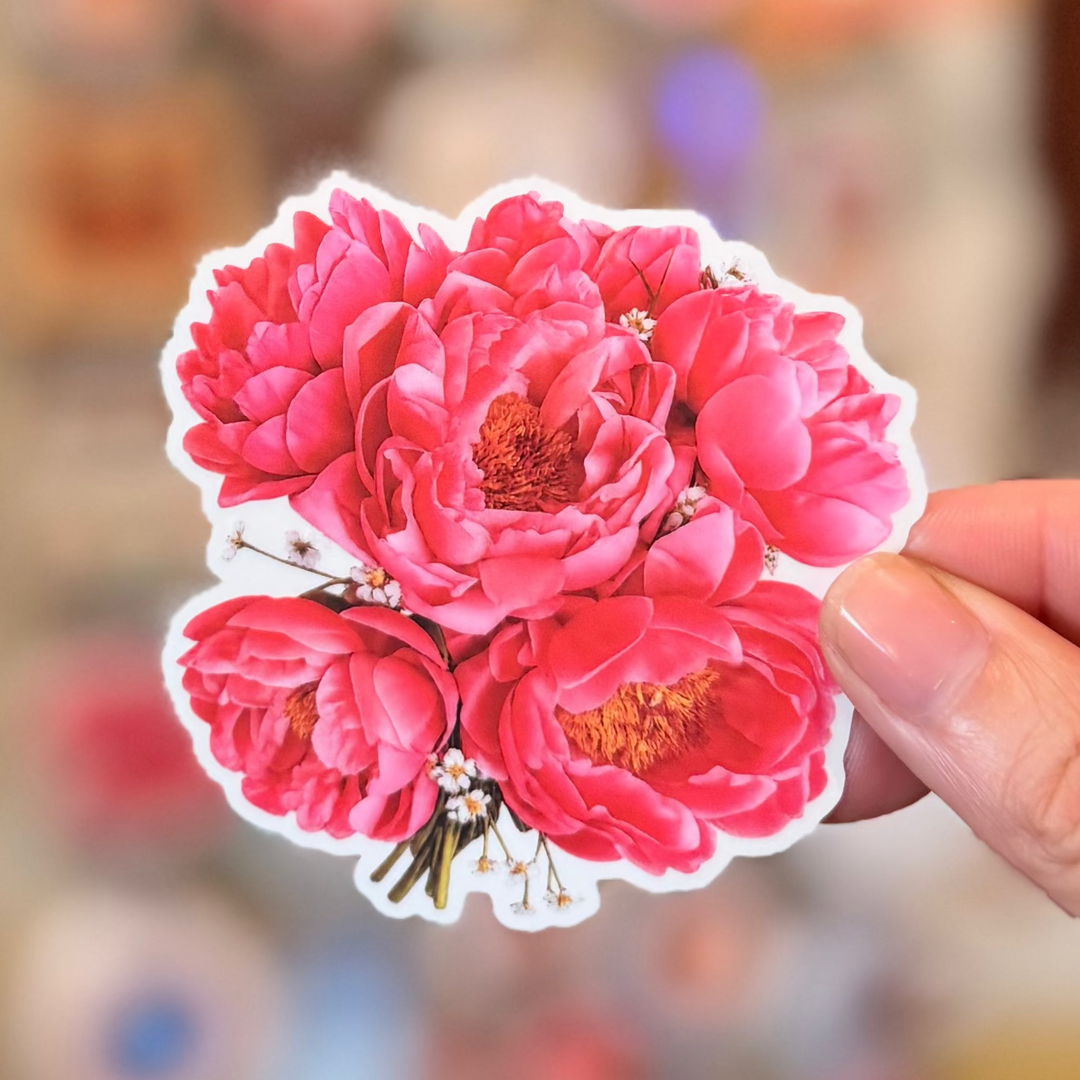 Sticker of pink flowers with green stems on a white background