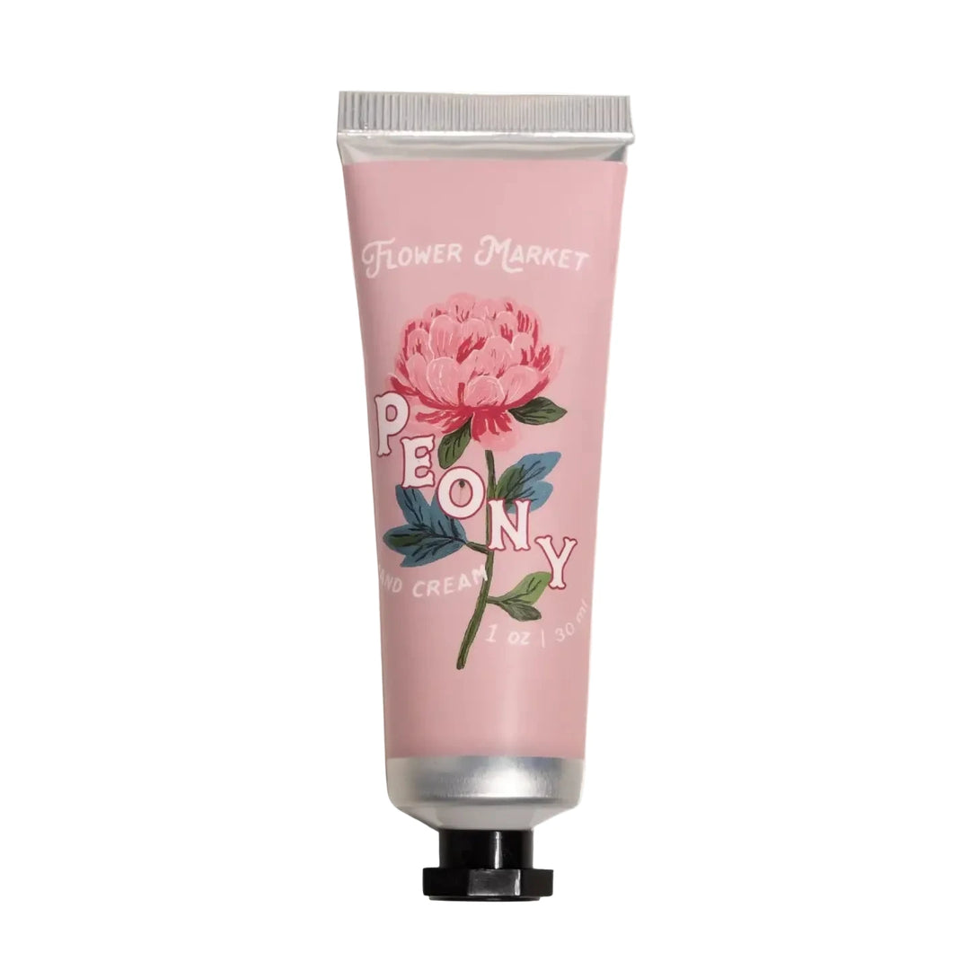 A 1 oz blush pink tube of Flower Market Peony Hand Cream with a bold illustrated peony bloom.