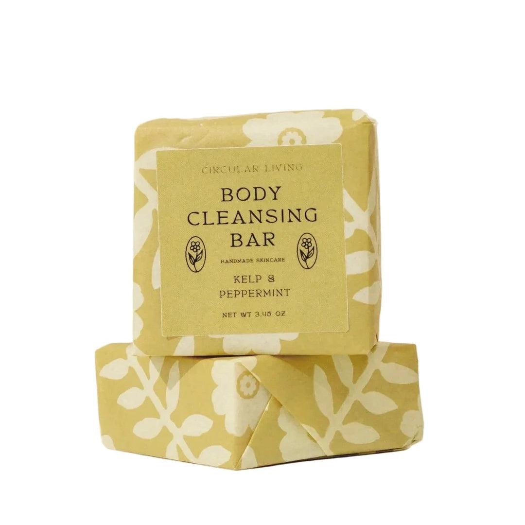 Two wrapped Peppermint and Kelp Body Cleansing Bars by Circular Living stacked on top of each other, wrapped in golden floral paper with a label reading Body Cleansing Bar, Kelp and Peppermint.