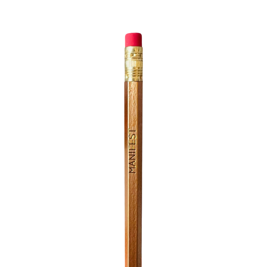 A wooden pencil with 'MANIFEST' printed in gold lettering on the side, topped with a red eraser.