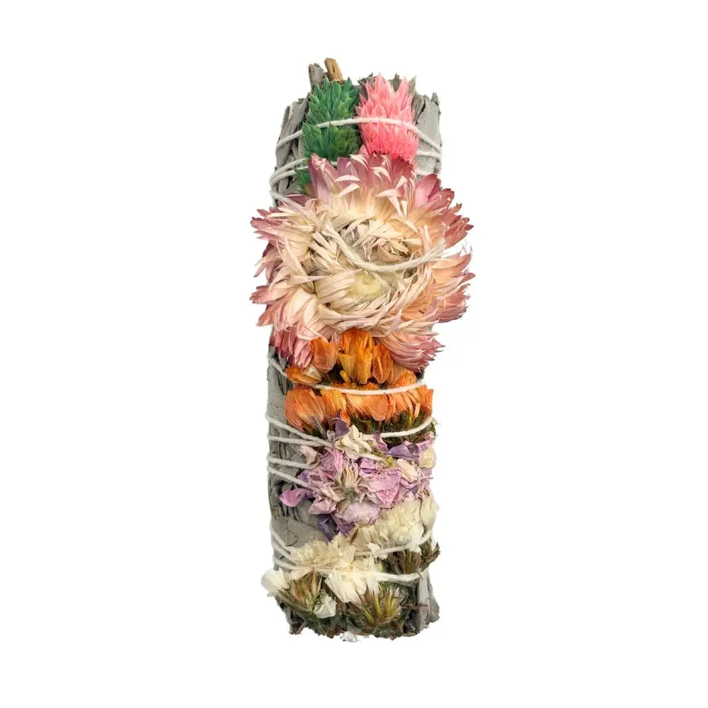 Sage bundle wrapped with pink and beige sinvata flowers and secured with white string.