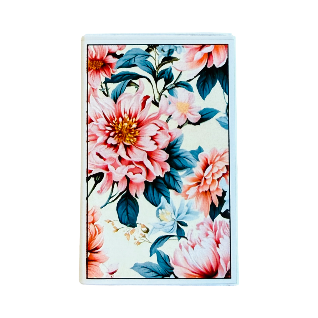 White rectangular book of matches with pink and green floral design.