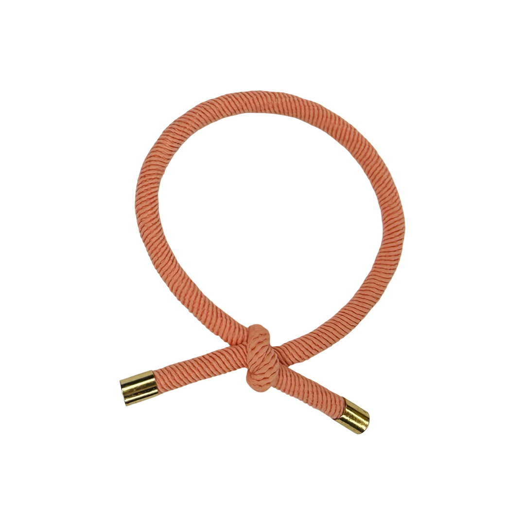 Pink elastic hair cord with knot closure with metal end caps. 