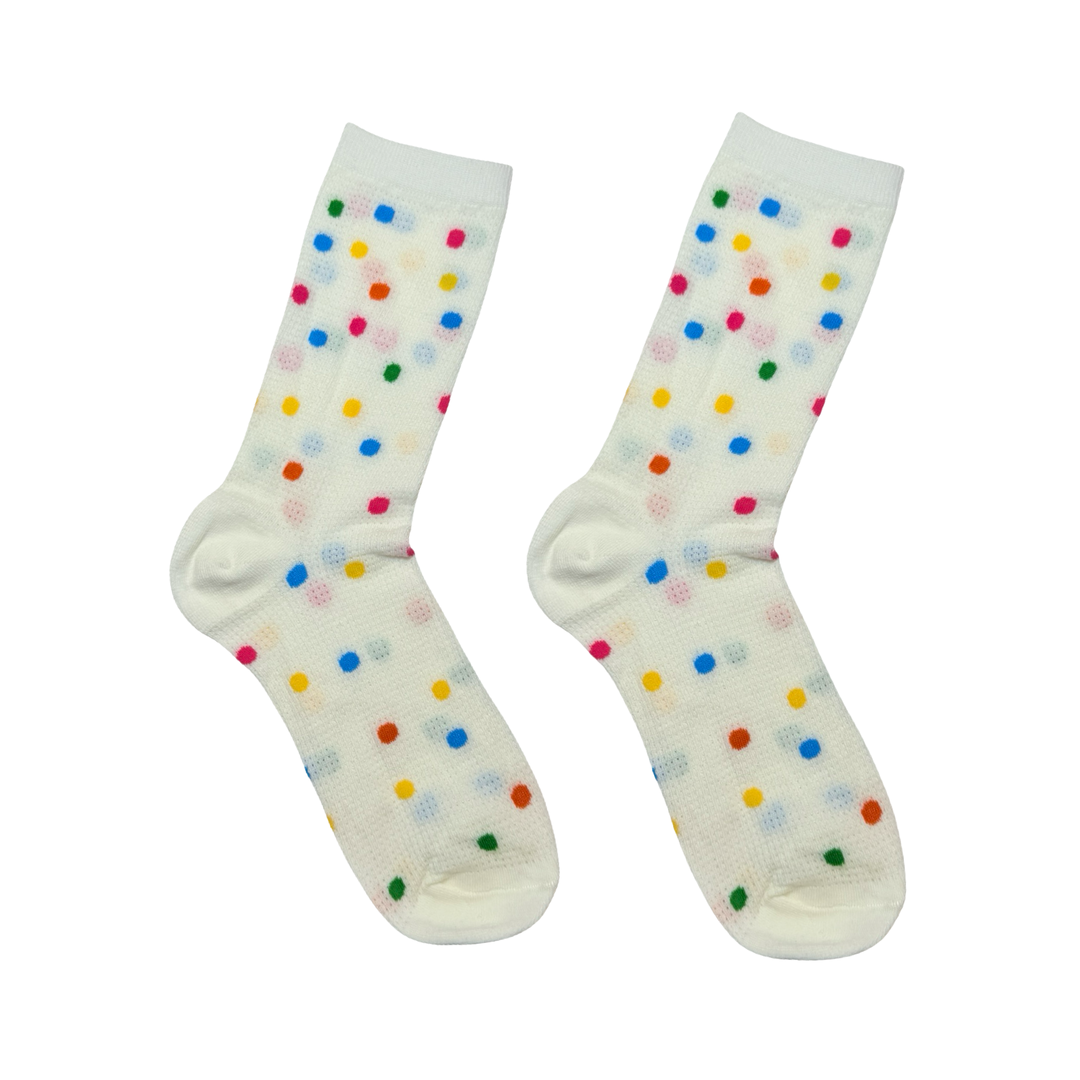 Pair of cream socks with rainbow polka dots.