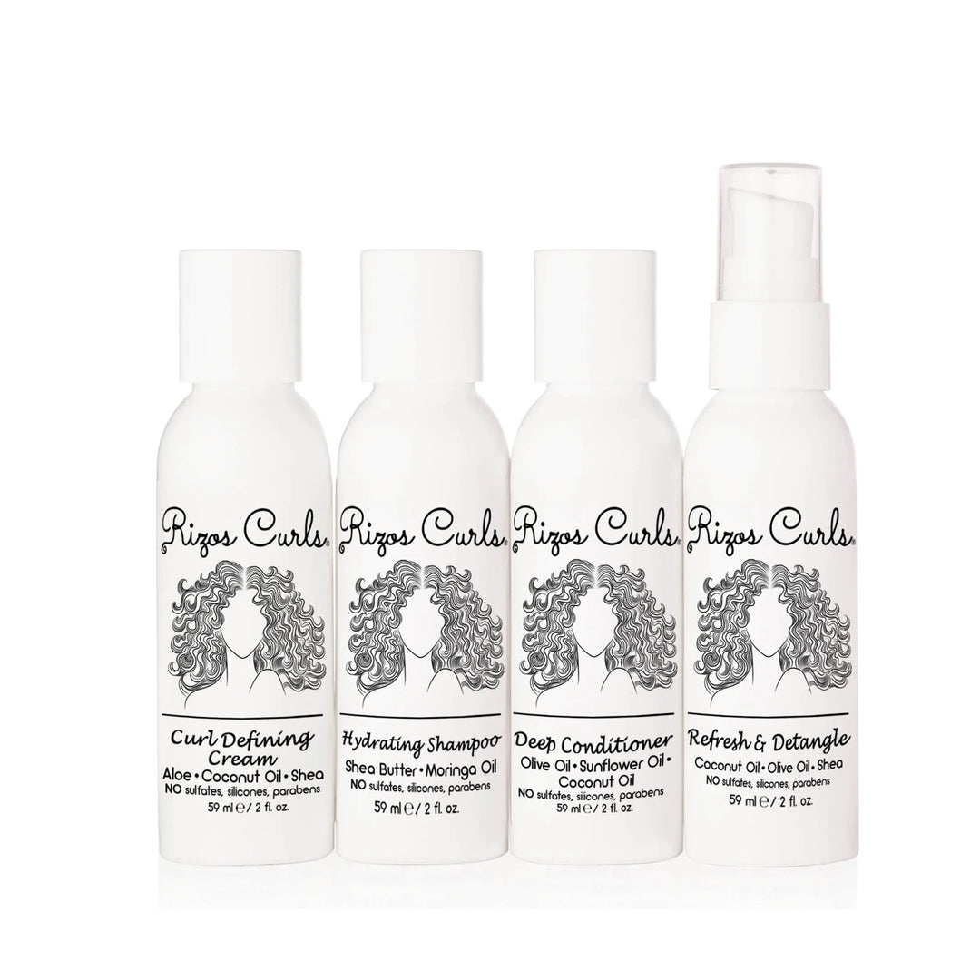 4 white branded bottles of products that feature an illustration of a woman with curly hair. Brand: Rizos Curls